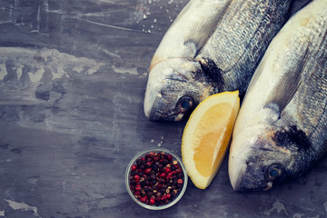 raw fish with olive oil and lemon background