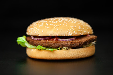fresh tasty burger on black background
