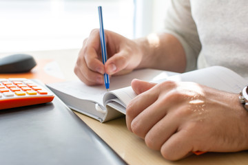 Businessman Working on Laptop for New Project. Notebook on the Table and Writing.