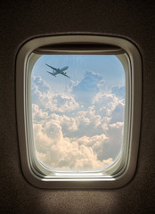 plane flying above the clouds, seen from window airplane.