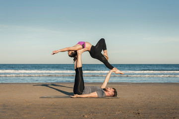 Young couple practicing acroyoga exercise