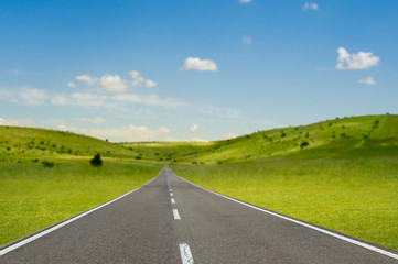 asphalt road through the sunny countryside