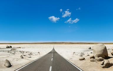 asphalt road through the sunny rocky landscape
