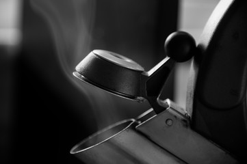 Close up of steaming tea kettle spout in black and white