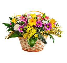 Beautiful spring bouquet of colorful flowers in wicker basket, isolated