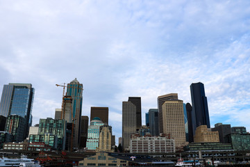 Fototapeta na wymiar Seattle, USA, August 31, 2018: Seattle waterfront Pier 55 and 54. Downtown view from ferry.