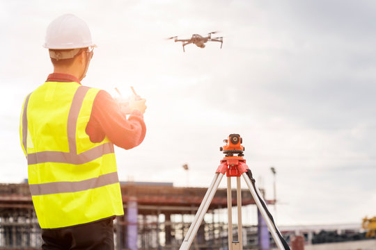 Engineer  working at construction Site with Drone over construction site.