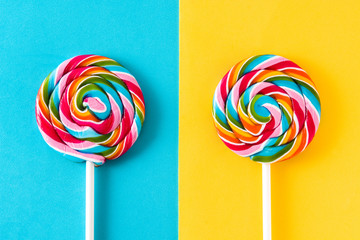 Colorful lollipops on blue and yellow background. 