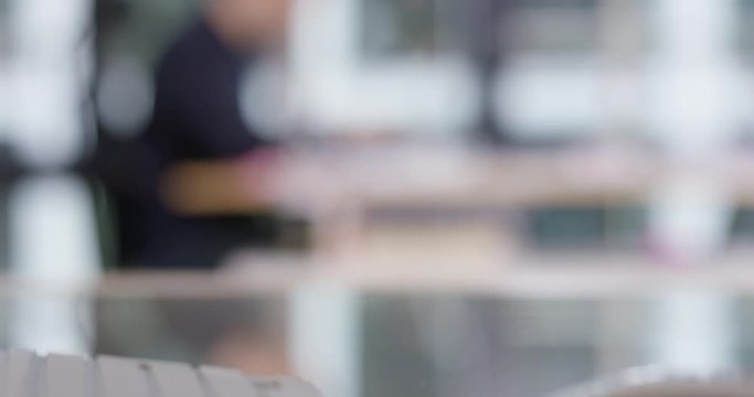 Blurry shot of person working in an office room, perfect to use as template