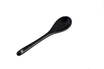 Black ceramic teaspoon isolate on white top view