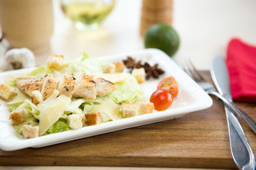 Plate of chicken salad on wooden table