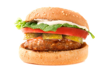 Hamburger with cheese, bacon, tomato and lettuce on white background