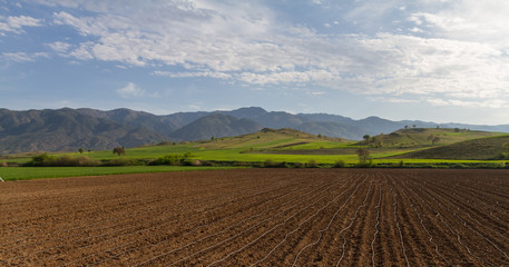 Fototapeta na wymiar Farm fields, countryside and mountains