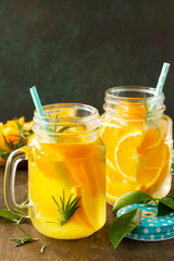 Cold summer drink set. Refreshing summer berry Lemonade, lemon mint Tea and orange Lemonade with rosemary. Copy space.