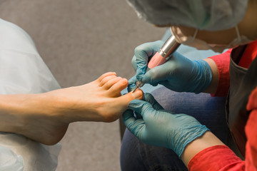 The procedure of a hardware pedicure in salon