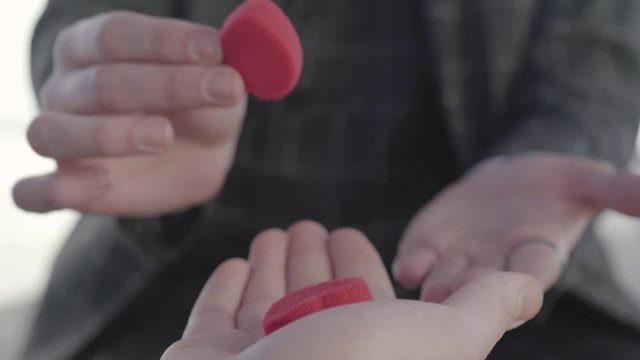 Professional magician shows tricks with paralon hearts. Disappearance