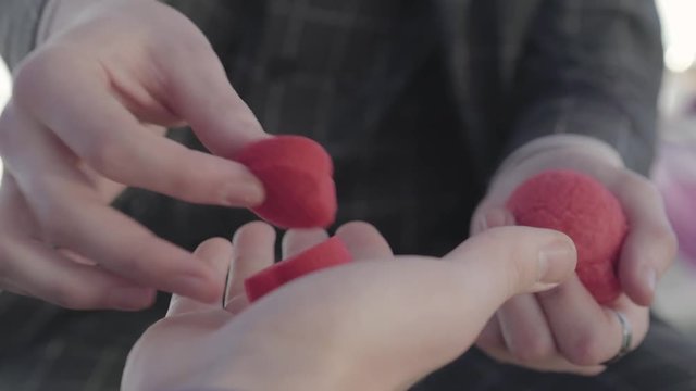 Professional magician shows tricks with paralon hearts.