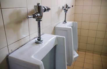 Close up urinals in empty male restroom