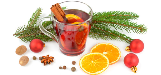 Hot red mulled wine isolated on white background with spices, orange slice, anise and cinnamon sticks. Wide photo
