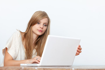 Young woman using a notebook computer indoors