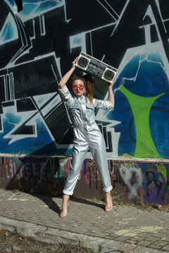 Girl In Front Of A Wall With Boombox