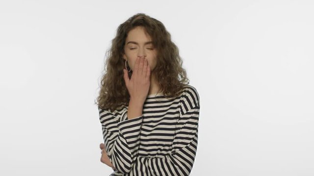 Young woman send air kiss in white studio. Portrait of pretty girl send air kiss
