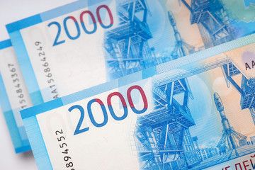 Russian banknotes 2000 rubles. The bills depict the Vostochny space center and the Soyuz rocket. View from above. Close-up