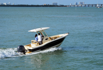 Blue and beige sport fishing boat cruising on the Florida Intra-Coastal Waterway