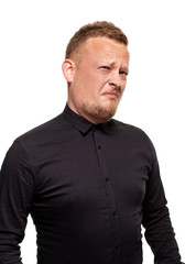 Close up portrait of a confident, blond, handsome young man wearing black shirt, isolated on white background