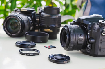 image of outdoor photographic equipment on a white table with natural light with assorted lenses