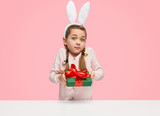 Girl with bunny ears giving present