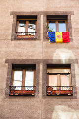 Fototapeta na wymiar La Vella, Andorra. A Flag of Andorra hanging out in a street