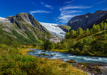 Fototapeta na wymiar Norwegian landscape with milky blue glacier river, glacier and green mountains. Norway