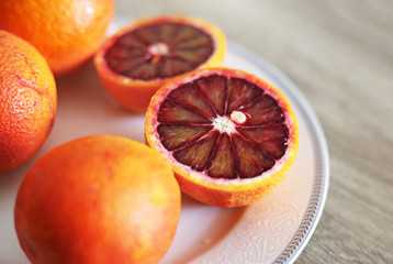 oranges in the plate - tarocco blood orange - sanguine orange - red orange