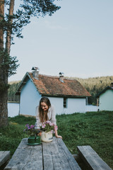 young woman in the garden with houses