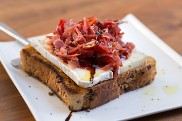Serrano ham toast, brie cheese and tomato marmalade.