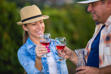Couple in Vineyard Harvesting Grapes and tasting vine