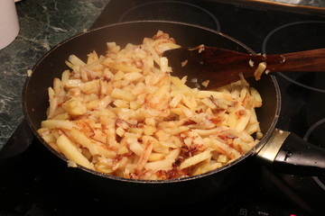 Fried potatoes in a frying pan.