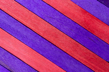 Purple diagonal colored wooden background with red stripes