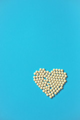 Assorted pharmaceutical medicine pills, tablets and capsules and bottle on purple background. Drugs and various narcotic substances. Copy space for text. Stock photo for design