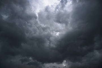 Dark, grim, stormy, rainy sky with rays of light. Scary hurricane clouds. Natural element. Stock...