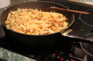 Fried potatoes in a frying pan.