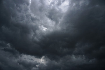 Dark, grim, stormy, rainy sky with rays of light. Scary hurricane clouds. Natural element. Stock...