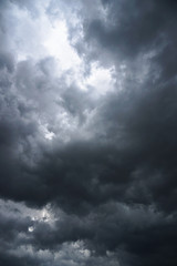 Dark, grim, stormy, rainy sky with rays of light. Scary hurricane clouds. Natural element. Stock...