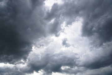 Obraz premium Dark, grim, stormy, rainy sky with rays of light. Scary hurricane clouds. Natural element. Stock Photo for your design