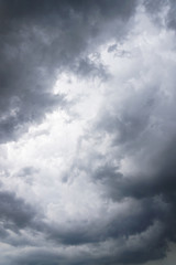 Dark, grim, stormy, rainy sky with rays of light. Scary hurricane clouds. Natural element. Stock...