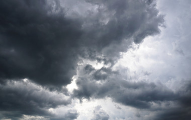 Dark, grim, stormy, rainy sky with rays of light. Scary hurricane clouds. Natural element. Stock...