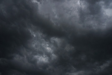 Dark, grim, stormy, rainy sky with rays of light. Scary hurricane clouds. Natural element. Stock...