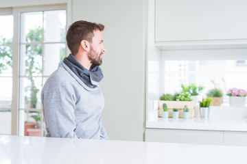 Handsome man at home looking to side, relax profile pose with natural face with confident smile.