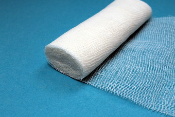 White sterile medical bandage on a blue background